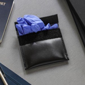 Black pouch with blue gloves on a gray surface