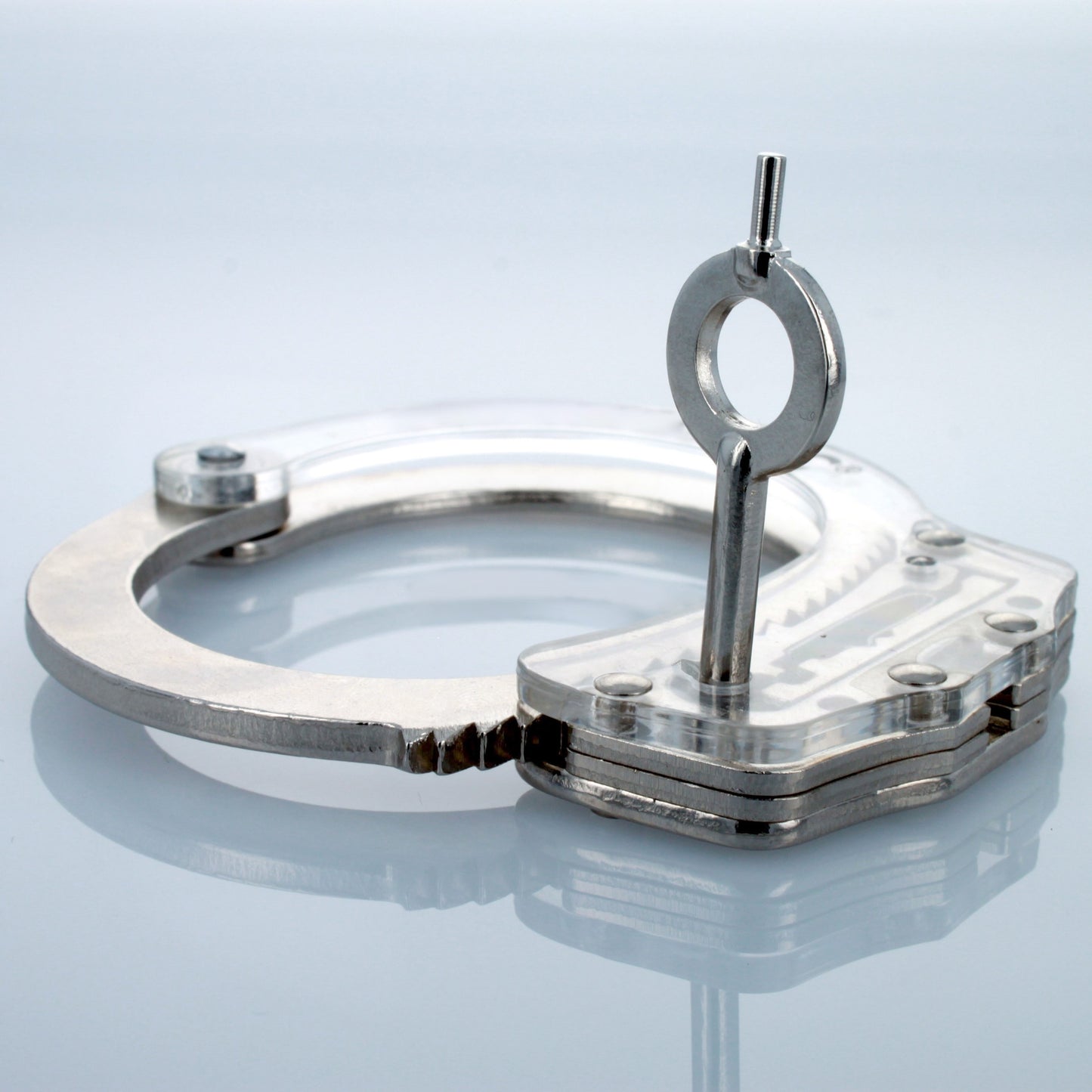Universal handcuff key inserted into handcuff lock.