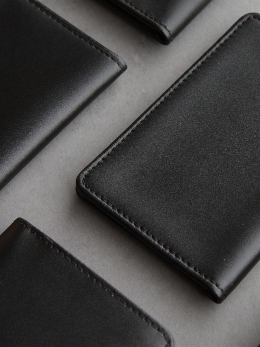 flay lay of an assortment of closed leather wallets and badge ID holders 
