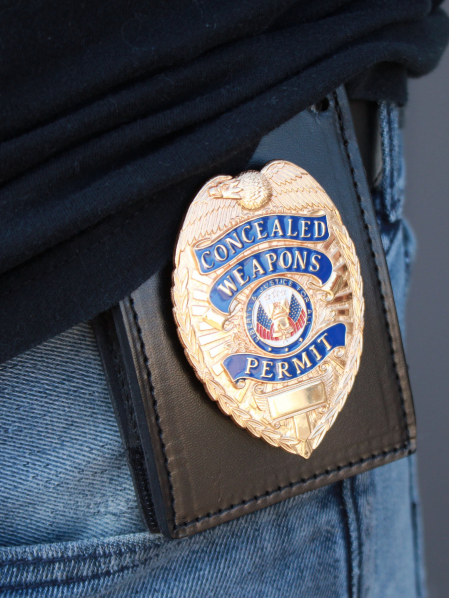 leather badge holder attached to persons hip with badge