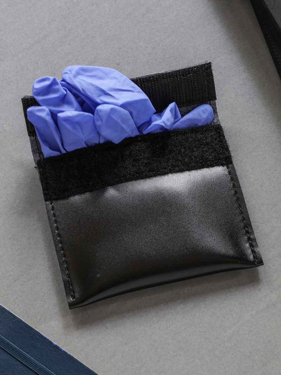 leather latex glove holder with velcro closure on gray backround